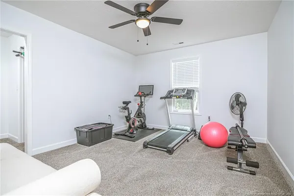 a living room with furniture and a fan