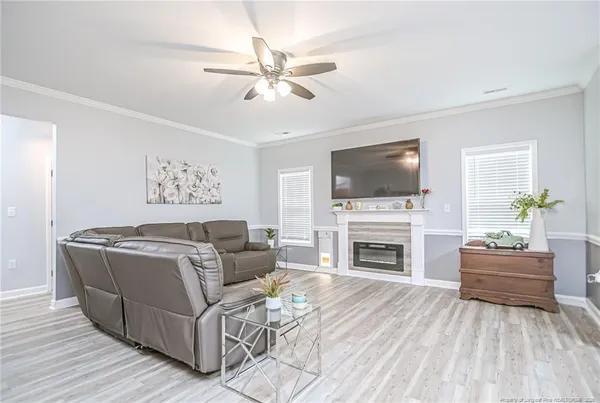 a living room with furniture fireplace and flat screen tv