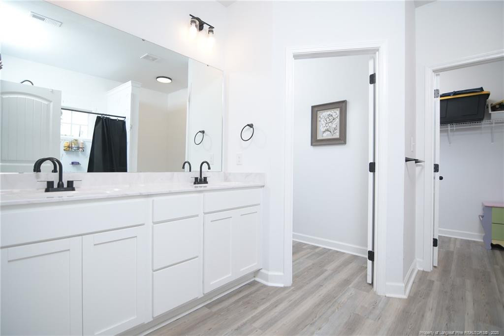 265 St Matthew Ch Road Raeford, NC 28376 - Photo 8 of 21 a bathroom with a double vanity sink and mirror