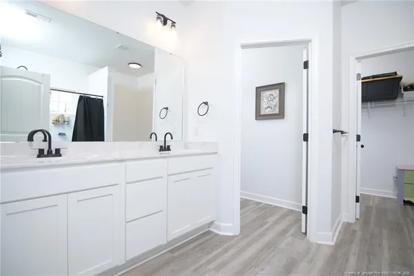 a bathroom with a double vanity sink and mirror
