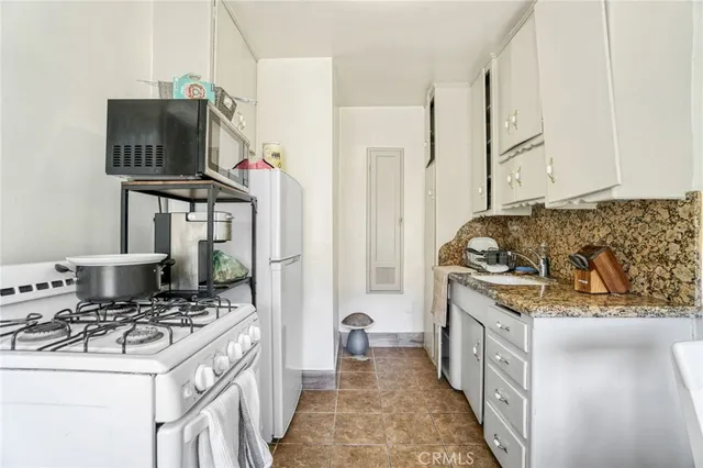 a kitchen with stainless steel appliances granite countertop a stove and a sink