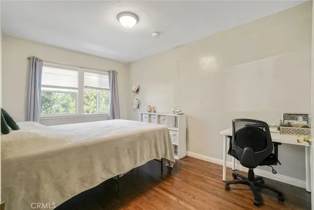 a bedroom with a bed and a chair