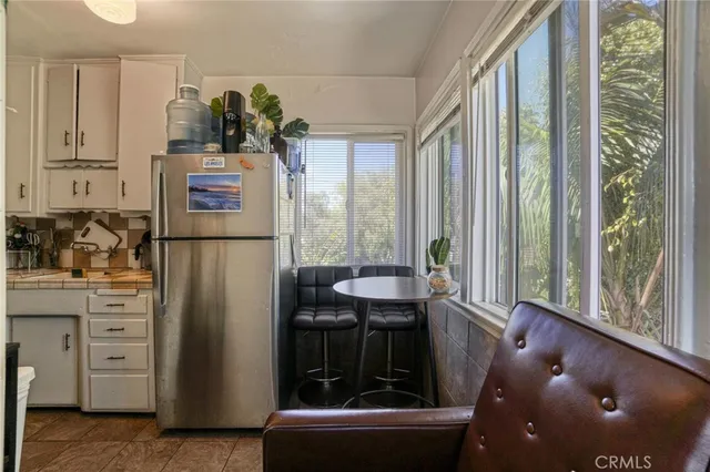 a kitchen with refrigerator and window