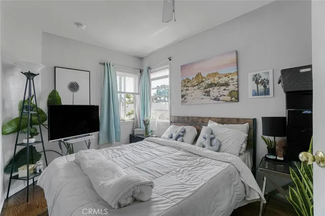 a bedroom with a bed and a flat screen tv