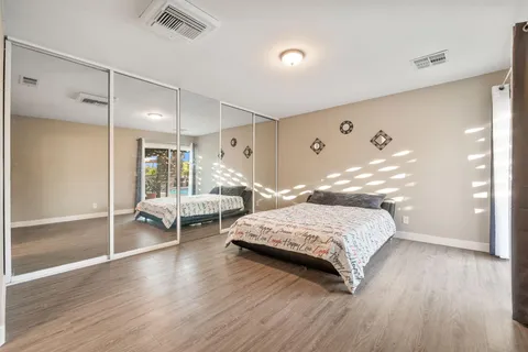 a bedroom with a large bed and a walk in closet