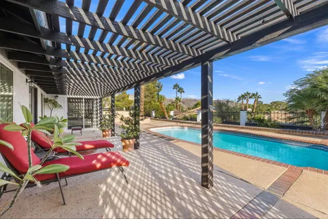 a outdoor sitting area with furniture and wooden floor