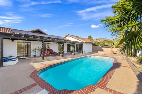 a view of a swimming pool with a house