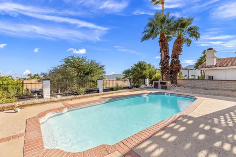 a living room with patio furniture and a potted plants