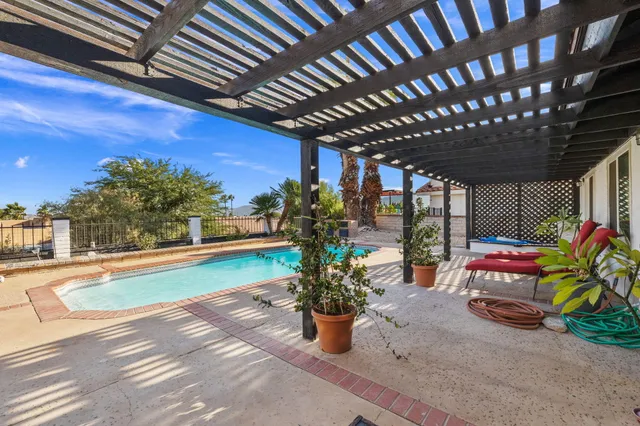 a view of a patio with table and chairs and potted plants
