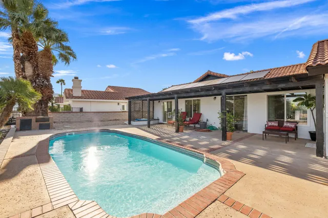 a view of a swimming pool with a patio