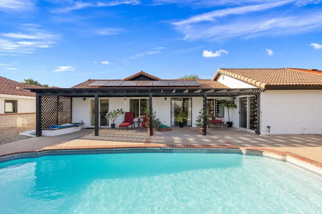 a view of a balcony with furniture and a garden