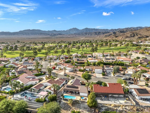 a front view of a house with a yard and seating area