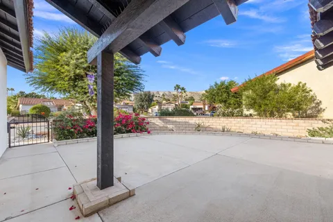 a view of a hallway with wooden floor and a potted plant