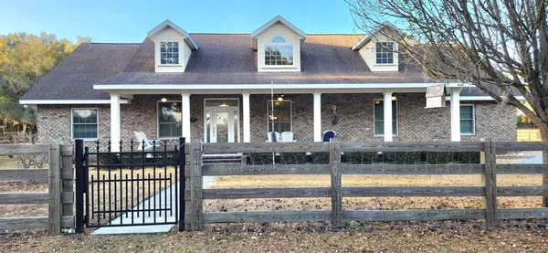 a view of a brick house with a swimming pool