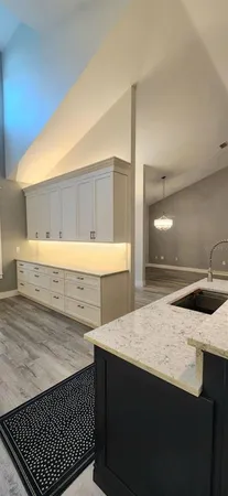 a kitchen with granite countertop a sink and a stove