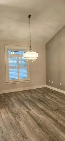 a view of a room with window and ceiling fan