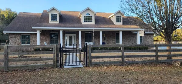 a view of a house with a fence