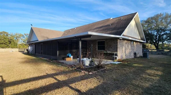 a view of house with backyard space and patio