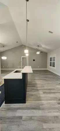 a view of a room with wooden floor