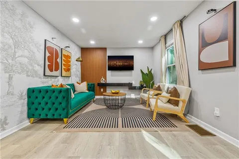a living room with furniture and a flat screen tv