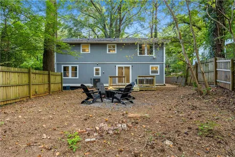 a backyard of a house with table and chairs