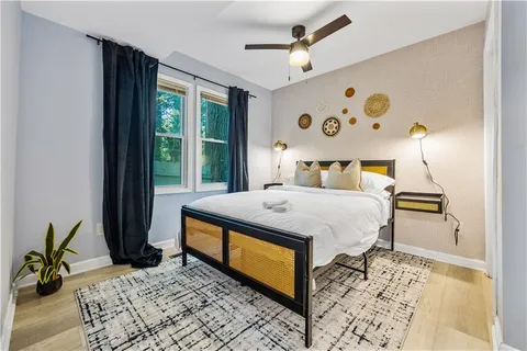 a bed sitting in a bedroom next to a window