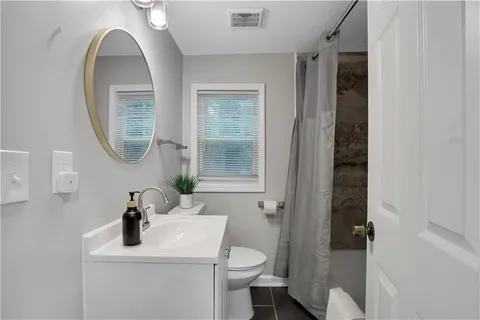 a view of kitchen with refrigerator and wooden floor