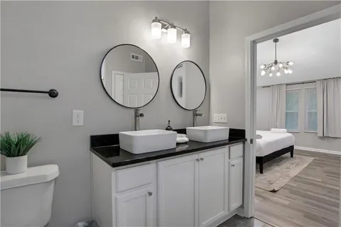 a kitchen with granite countertop a refrigerator and a stove top oven