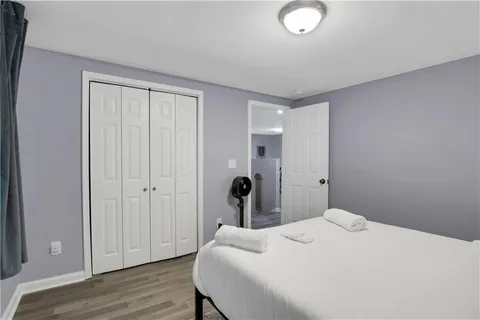 a bedroom with a bed and a rug