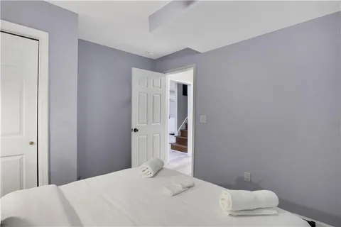 a living room with furniture a flat screen tv and a window