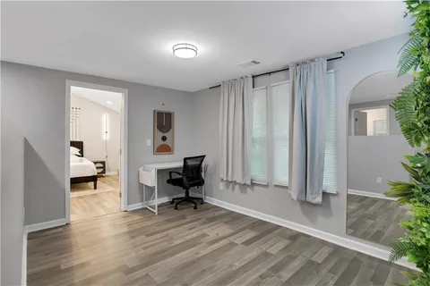 a large bed sitting in a bedroom next to a cabinet