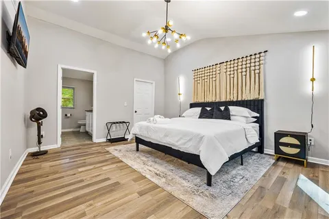 a bedroom with a bed and a chandelier