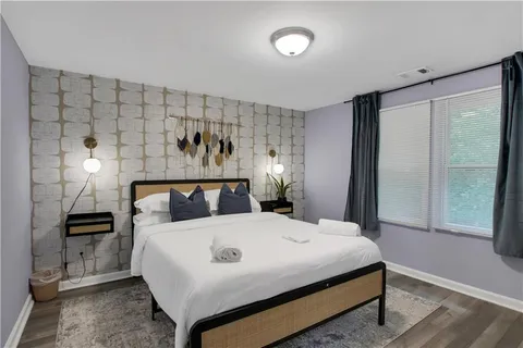 a bedroom with a bed and a mirror