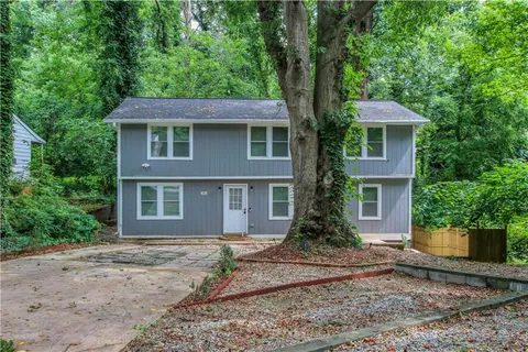 a view of a bedroom with wooden floor and furniture