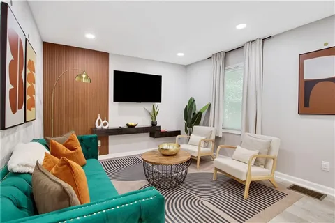 a bed sitting in a spacious bedroom next to a window