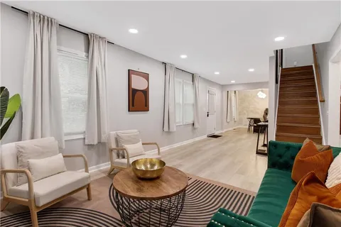 a living room with furniture and a painting