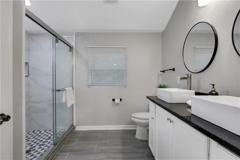 a large bedroom with bed and a window