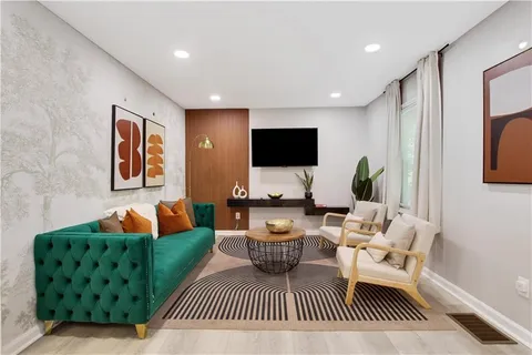 a view of kitchen with granite countertop cabinets and black appliances