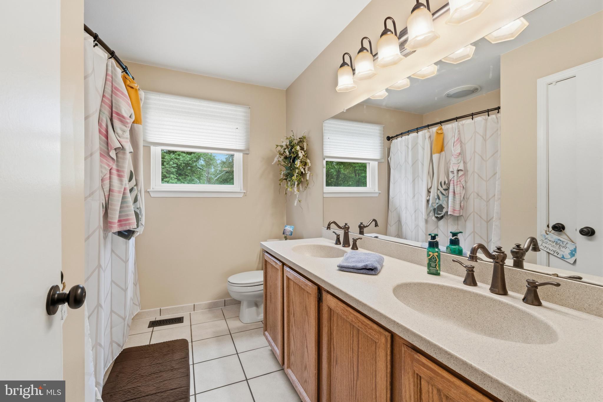 2 Farnham Court Laurel Springs, NJ 08021 - Photo 20 of 33 a bathroom with a double vanity sink mirror and toilet