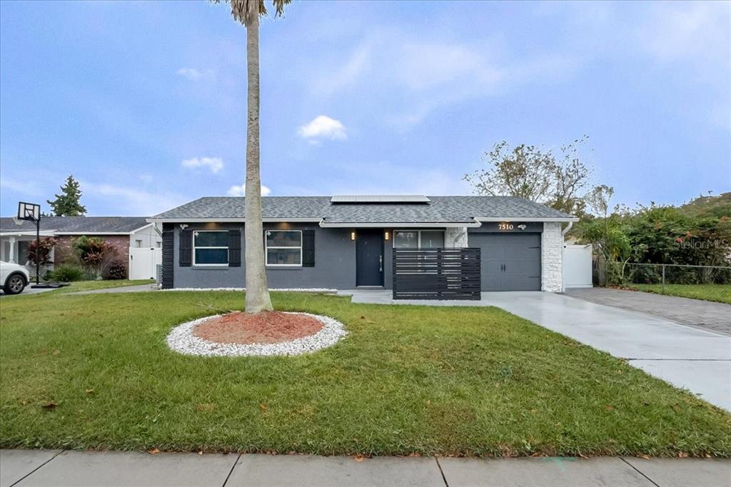 7510 Rio Pinar Lakes Boulevard Orlando, FL 32822 - Photo 1 of 1 a front view of a house with a garden