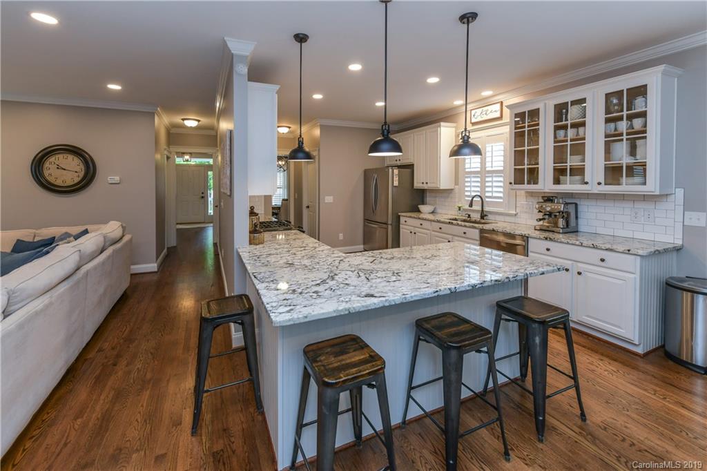 413 Esther Court Fort Mill, SC 29708 - Photo 9 of 28 a kitchen with granite countertop kitchen island stainless steel appliances a stove a sink a oven cabinets and living room view