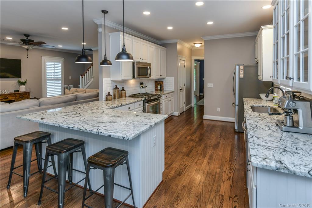 413 Esther Court Fort Mill, SC 29708 - Photo 10 of 28 a kitchen with granite countertop kitchen island stainless steel appliances a sink and counter space