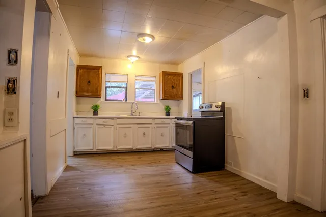 a view of a hallway with wooden floor