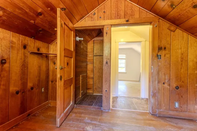 a view of empty room with wooden floor and fireplace