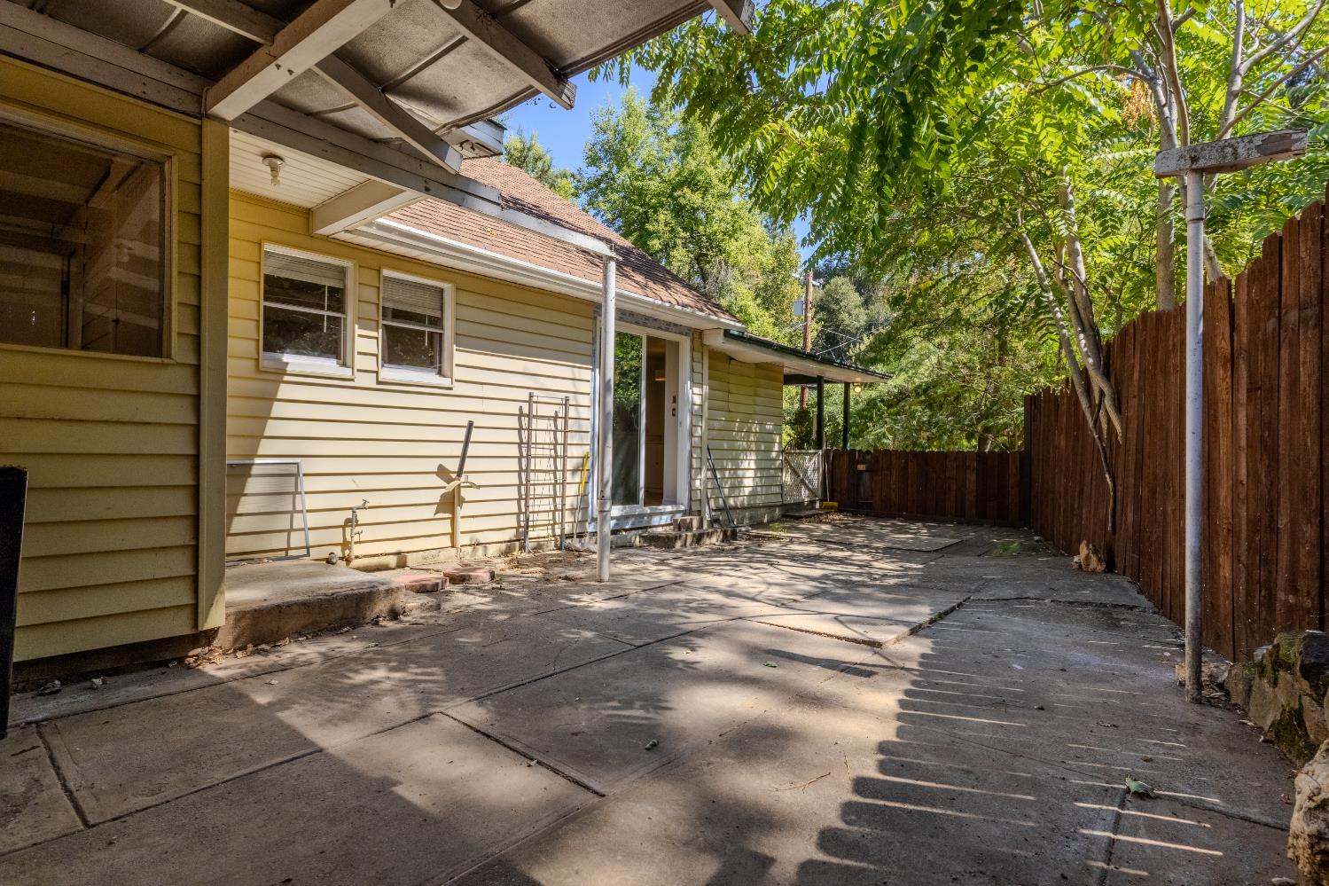 2896 Clay Street Placerville, CA 95667 - Photo 25 of 38 a view of a backyard with large trees and wooden fence