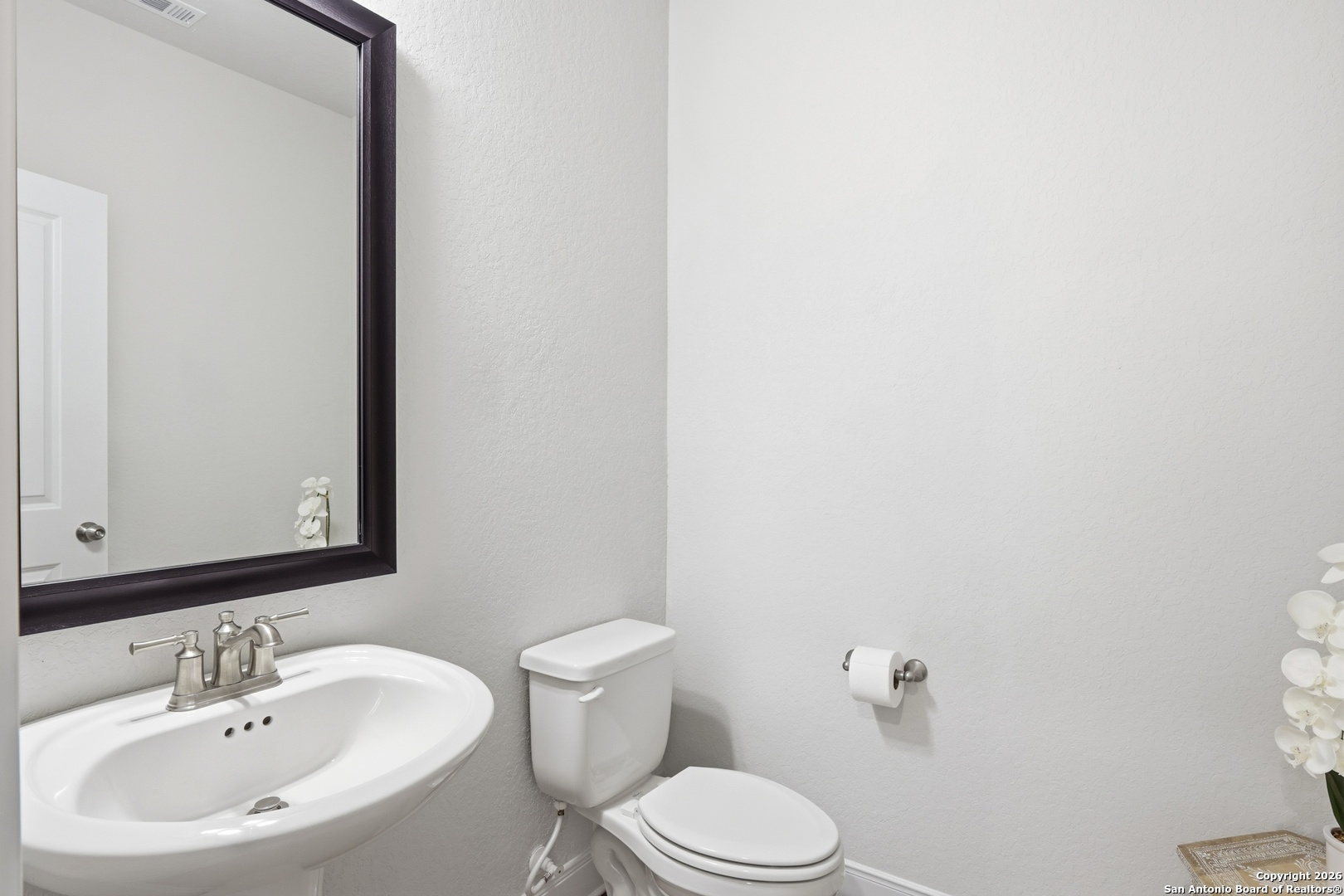 8334 Two Winds San Antonio, TX 78255 - Photo 14 of 39 a bathroom with a sink a toilet and mirror