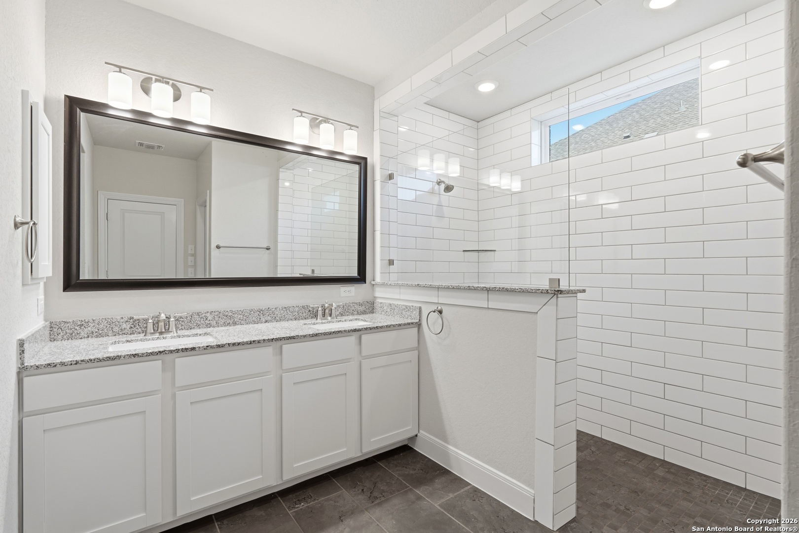 8334 Two Winds San Antonio, TX 78255 - Photo 16 of 39 a bathroom with a double vanity sink and mirror