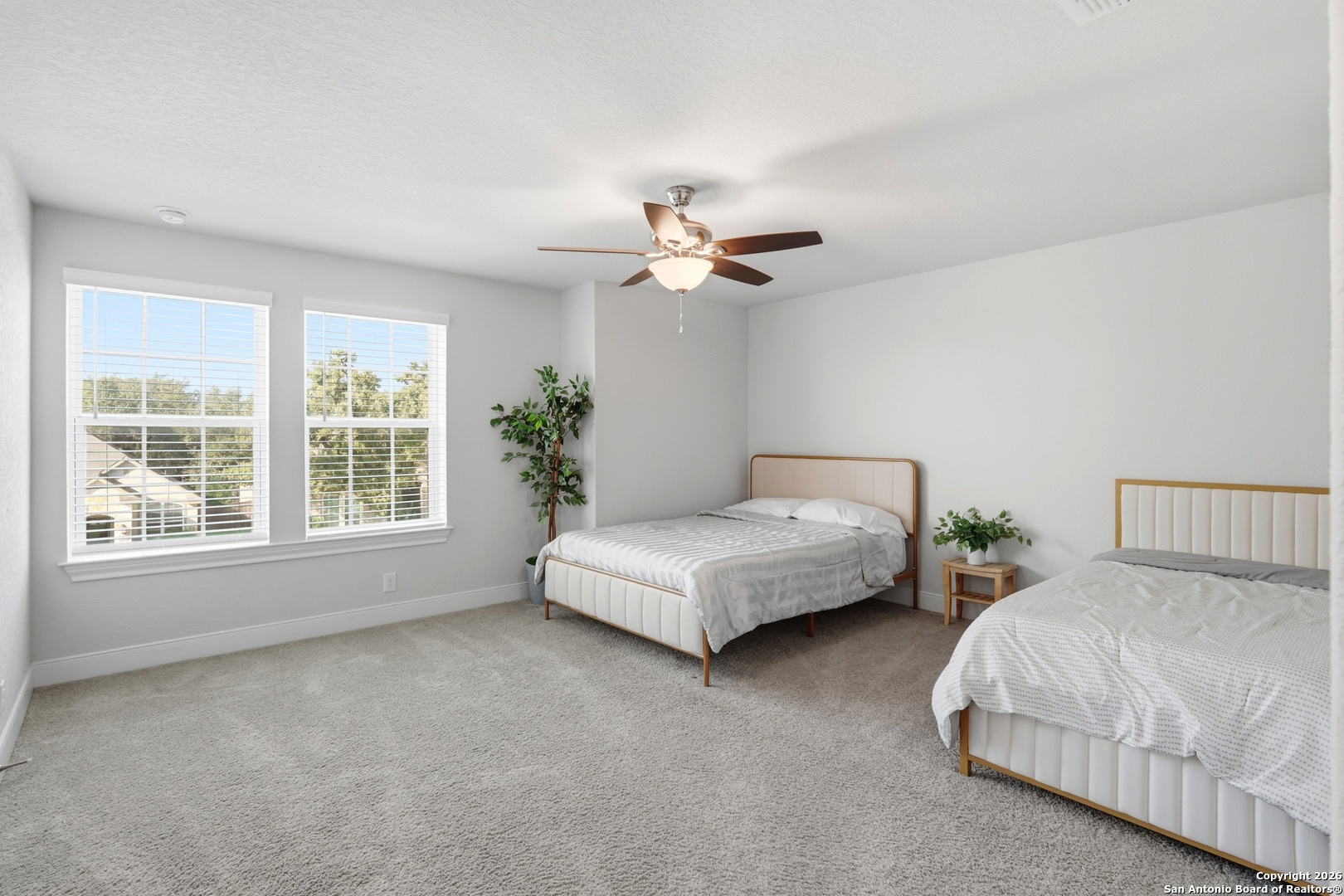 8334 Two Winds San Antonio, TX 78255 - Photo 19 of 39 a spacious bedroom with a bed and a large window