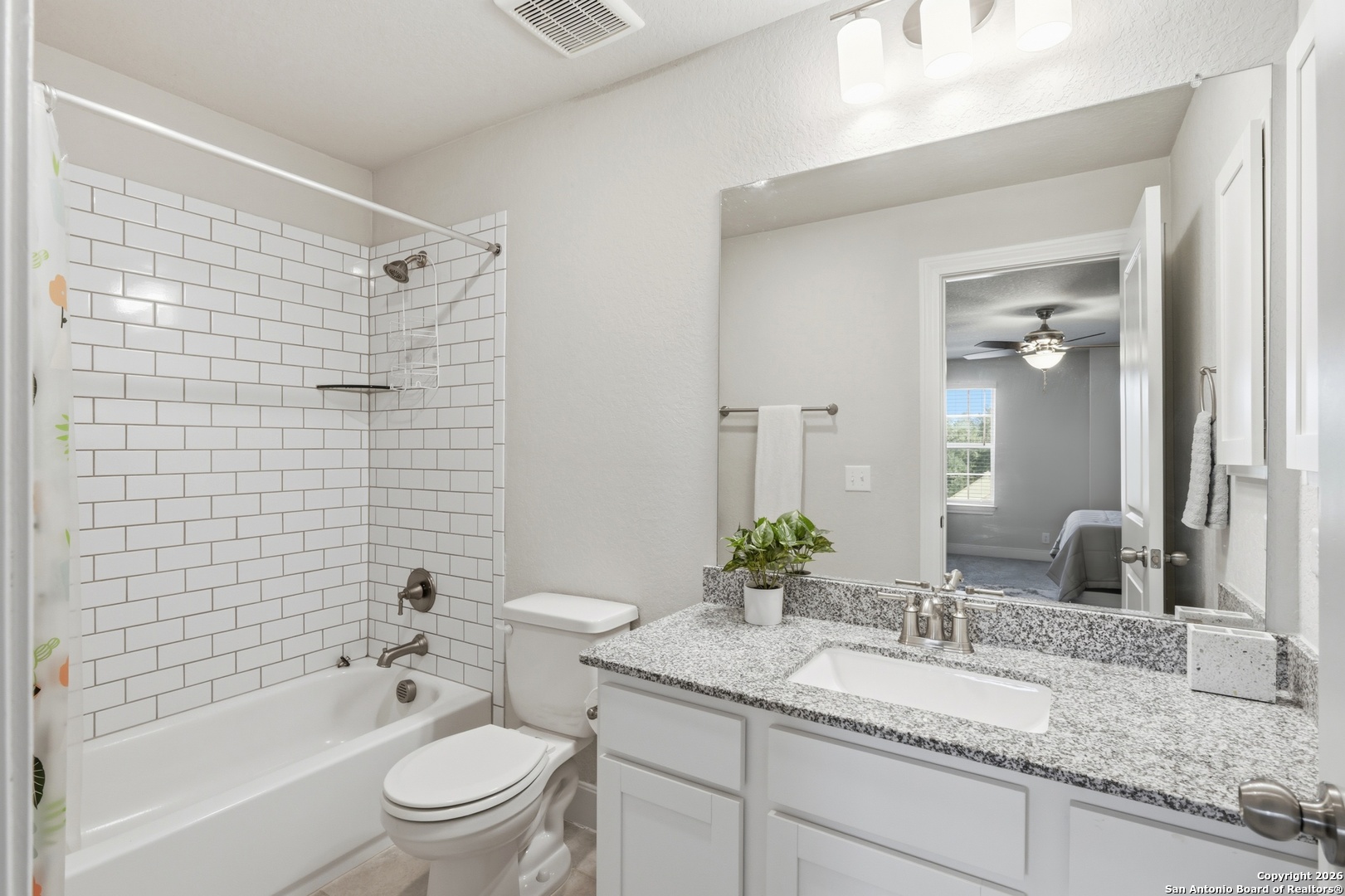 8334 Two Winds San Antonio, TX 78255 - Photo 22 of 39 a bathroom with a granite countertop sink a toilet a mirror and shower