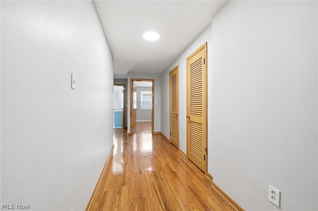 2537 Edgewood Road Beachwood, OH 44122 - Photo 24 of 39 Hallway featuring wood-finish flooring, light-colored walls, recessed ceiling lighting, and louvered wood doors